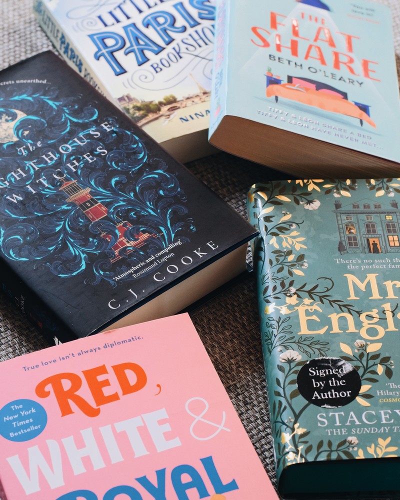 books scattered on grey fabric sofa